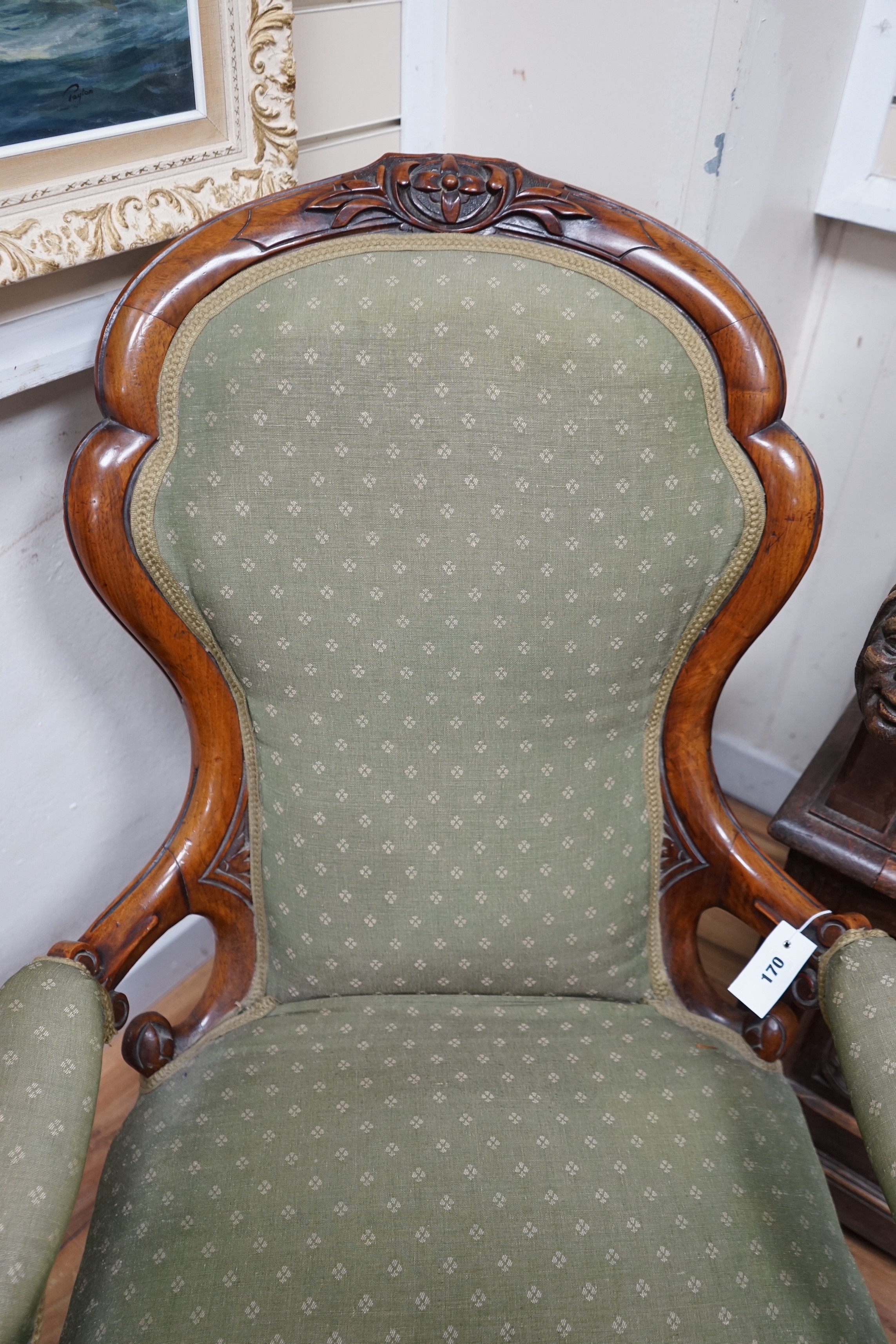 A Victorian walnut spoon back open armchair